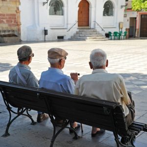 Three old men sitting on the bench, Spanish village